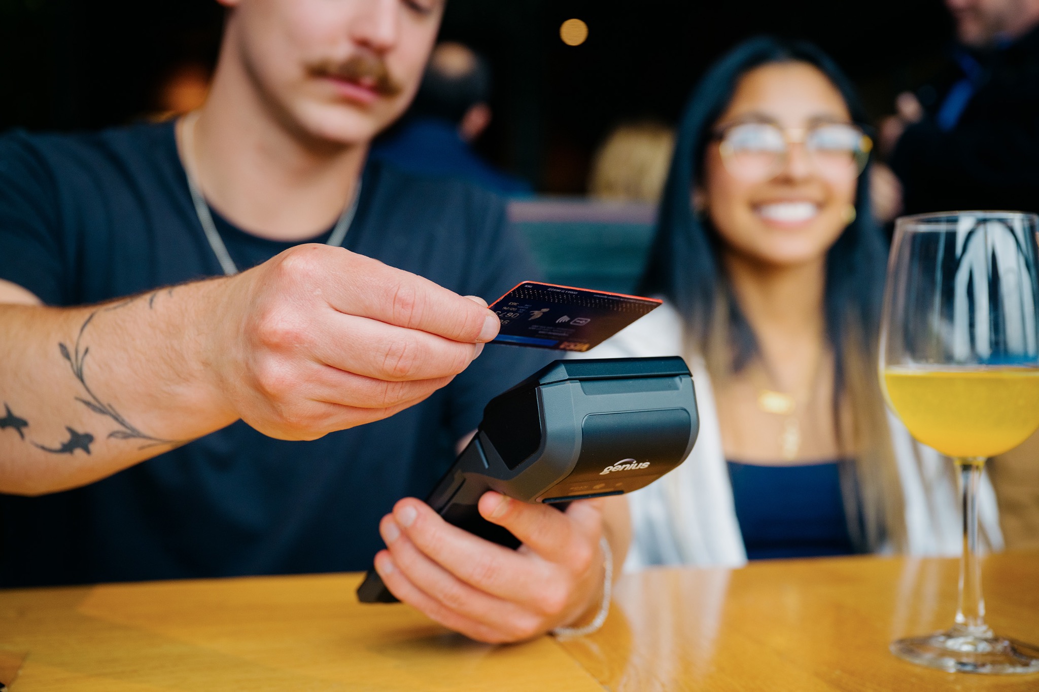 Restaurant guest paying with a Genius handheld device